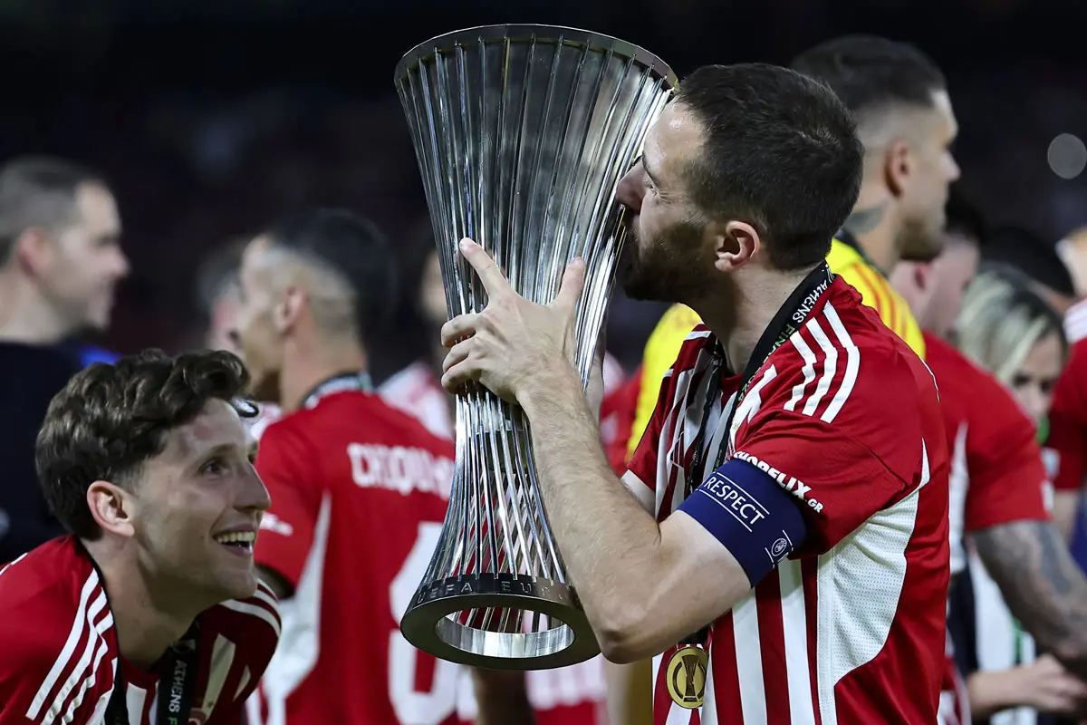 Kostas Fortounis of Olympiacos FC kisses the trophy at the end of the 2023/2024 Conference League Final football match between Olympiacos FC and ACF Fiorentina at AEK Arena stadium in Athens Greece